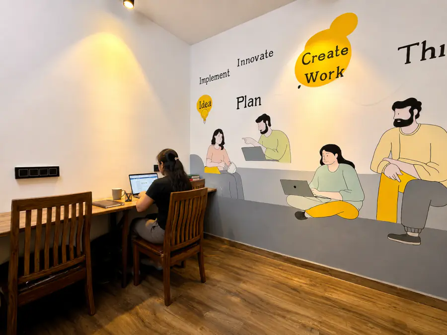 Guest working at a desk in the HOSHTEL99 Delhi coworking room