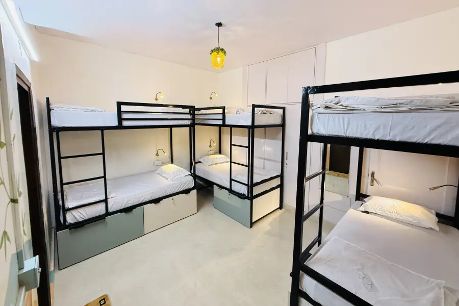 Wide HOSHTEL99 Delhi dorm with bunk beds and under-bed storage